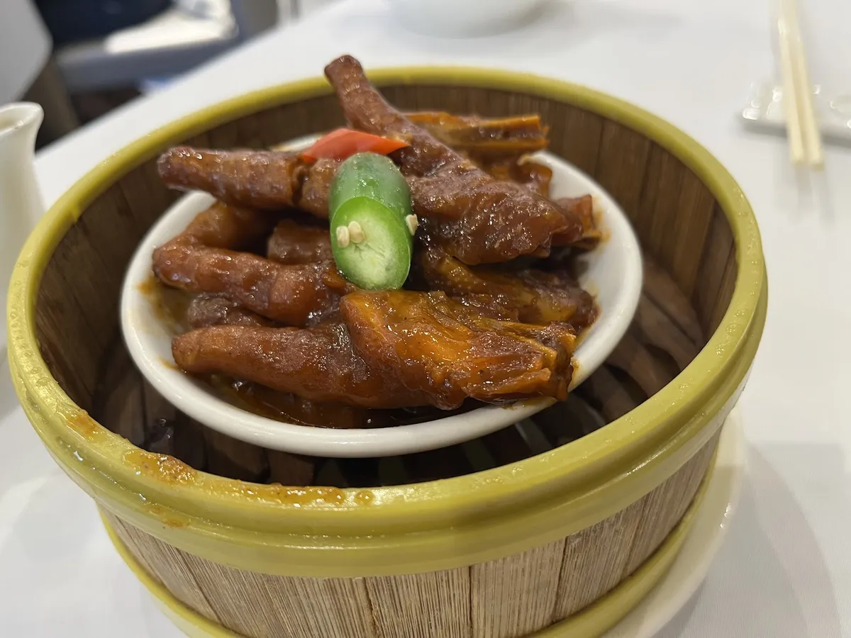 Braised chicken feet in a bamboo steamer